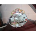 A decorative oval barbola mirror