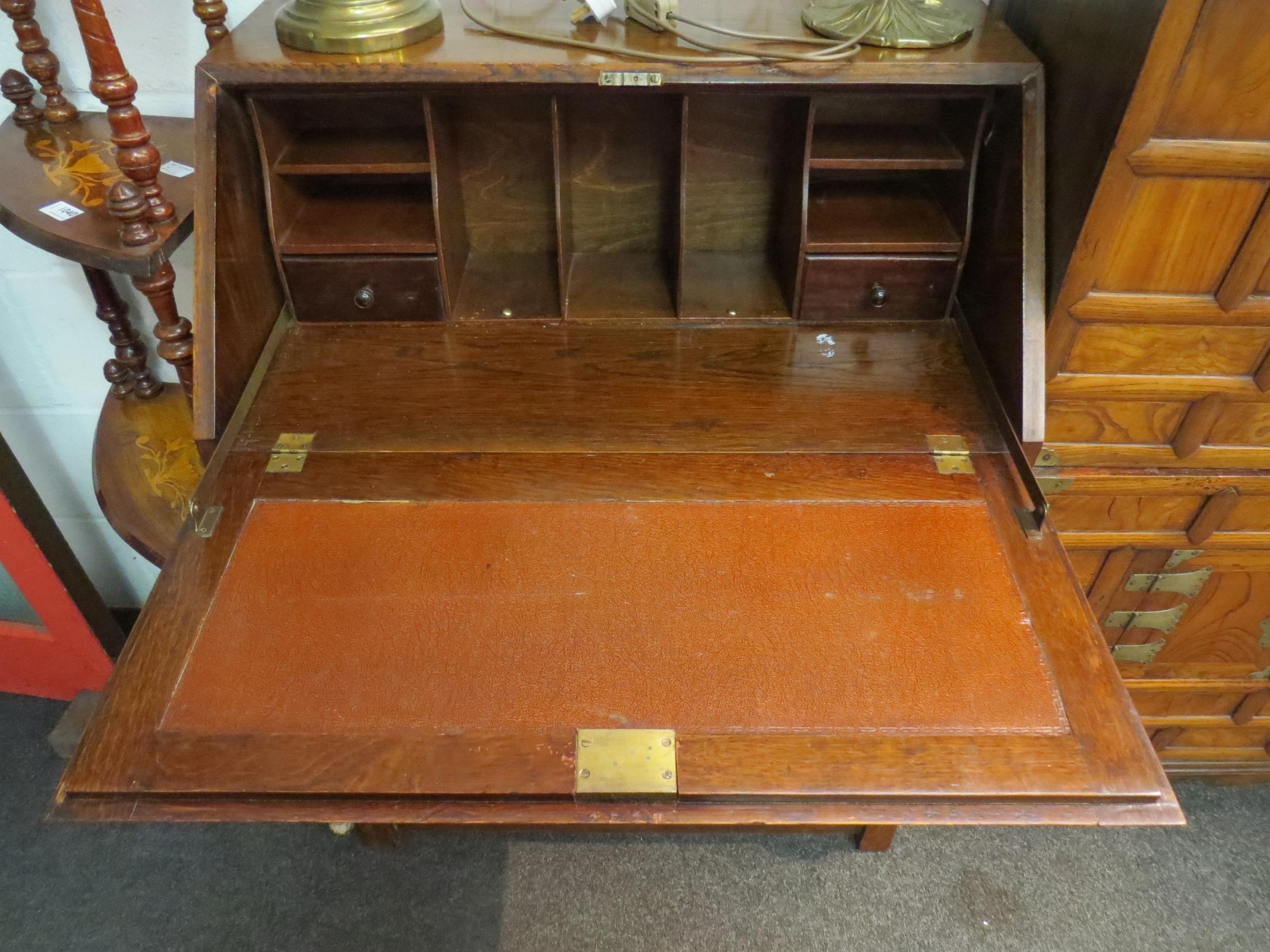 A 20th Century oak bureau, drop flap over three drawers to stretcher base, 103cm high x 78cm wide - Image 2 of 2
