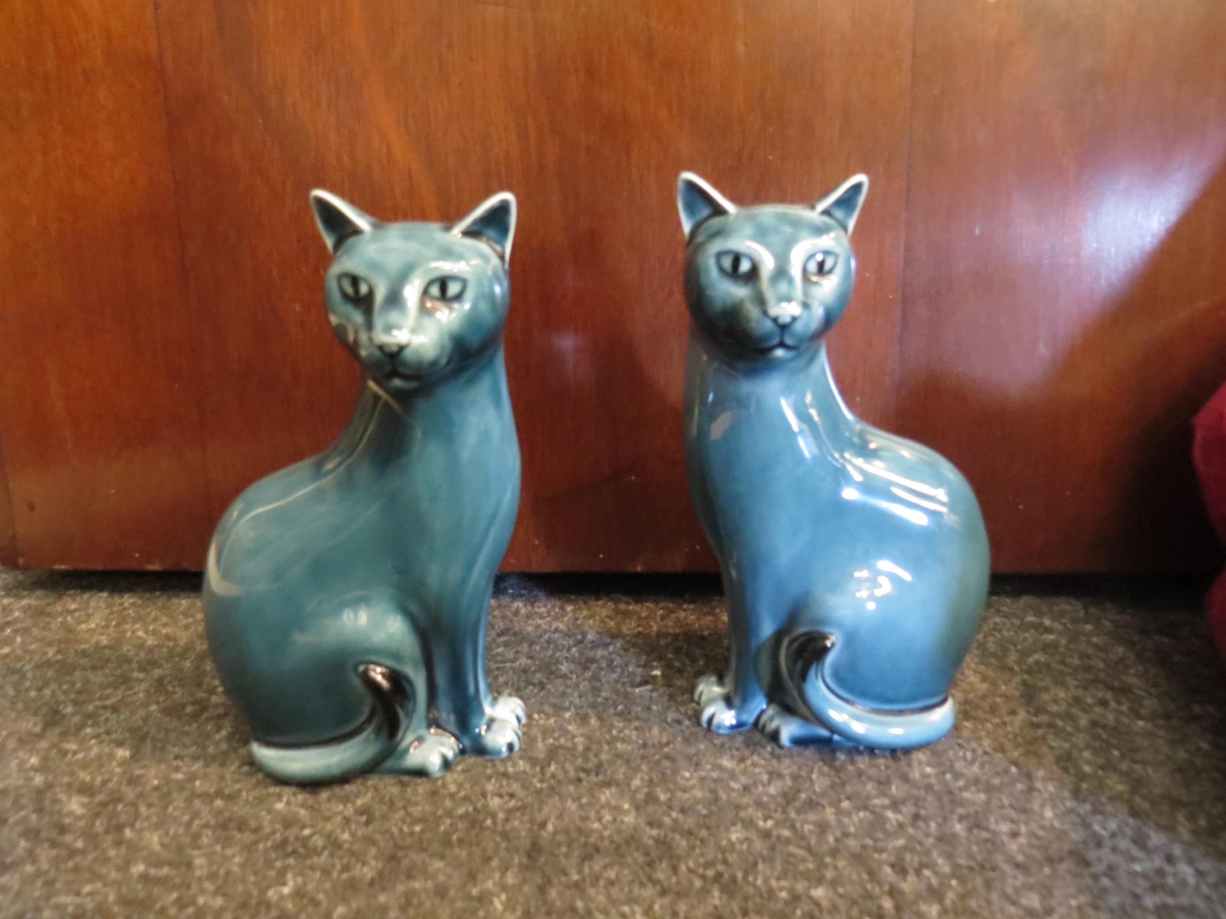 A pair of Poole pottery cats, 17cm high