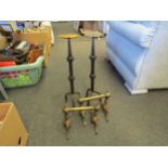 A pair of pricket candle stands and a pair of brass rests