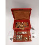 A jewellery box containing mainly silver items including compact, charm bracelet, Scottish silver