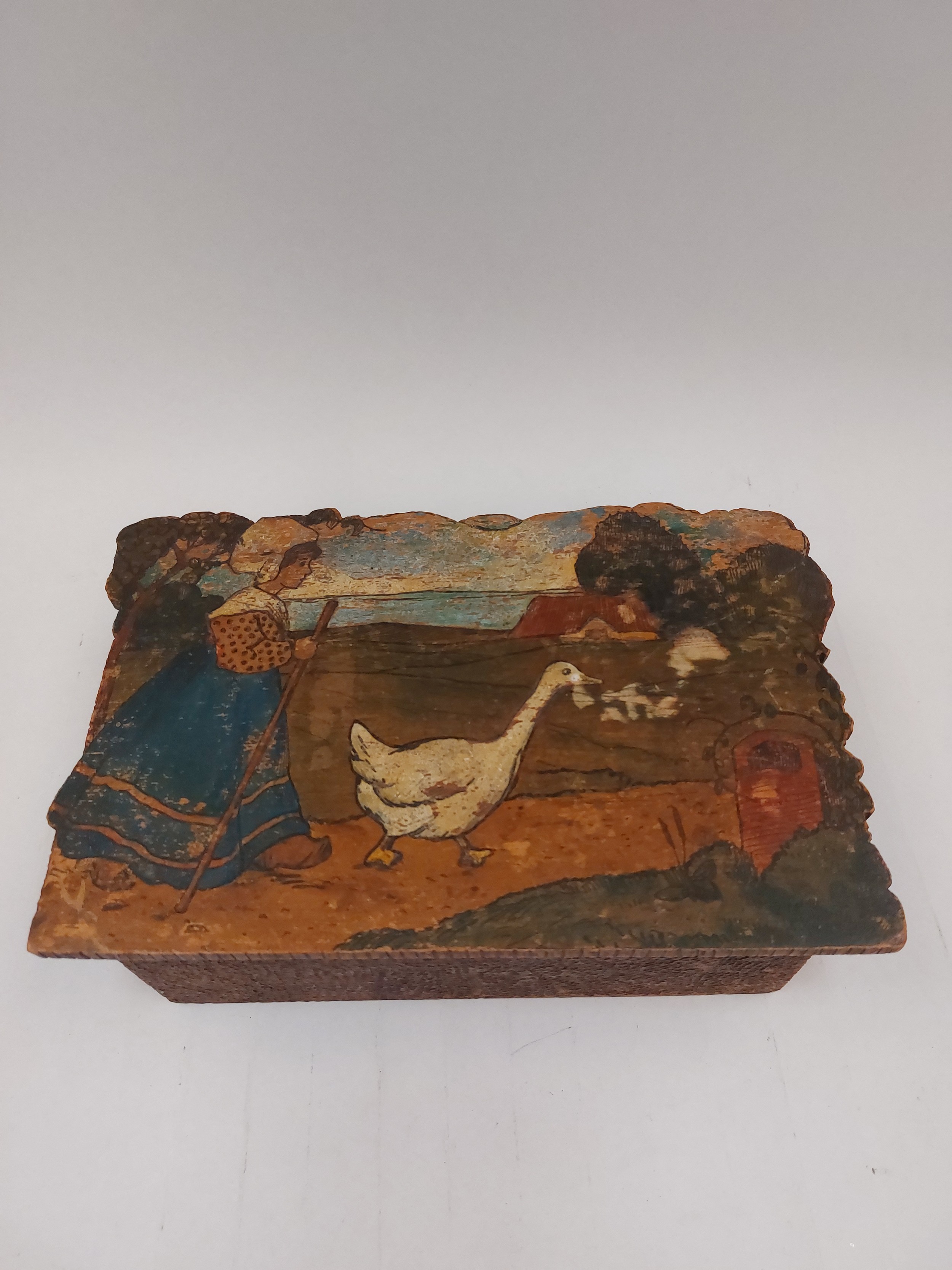 A pokerwork box with lid depicting girl walking a goose