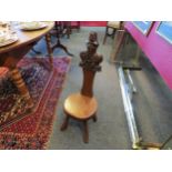 A 20th Century oak spinning chair, surmounted by an older pew-end "poppy-head" carving