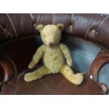 A vintage teddy bear with articulated limbs
