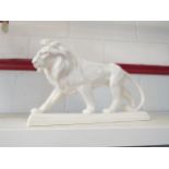 A ceramic lion figure, 38cm long x 22cm high