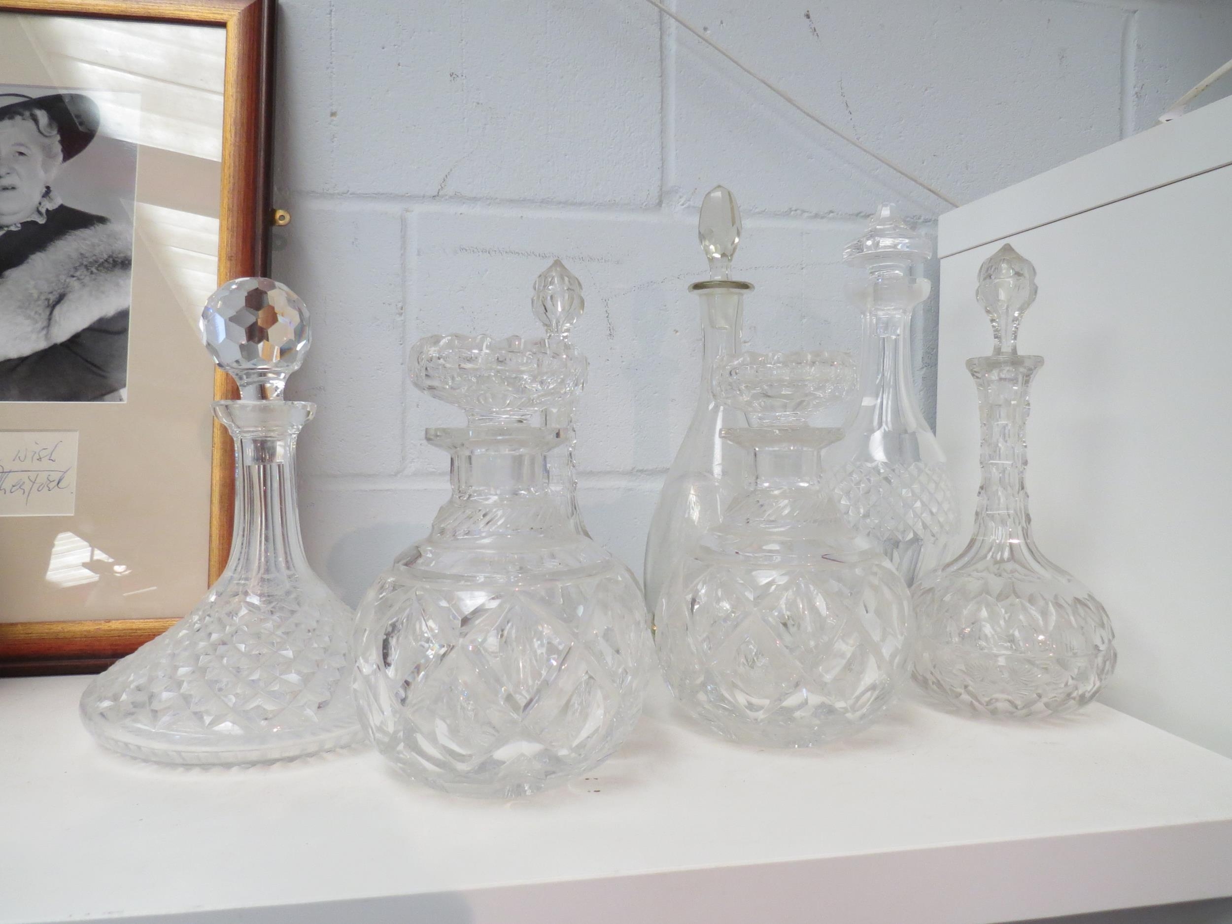 A collection of seven Victorian and later crystal and cut glass decanters including two pairs, a/