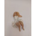 An East German figure of reclined beauty, various stamps verso, 16cm length