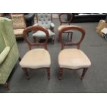 A set of three Victorian mahogany balloon back dining chairs on turned front legs