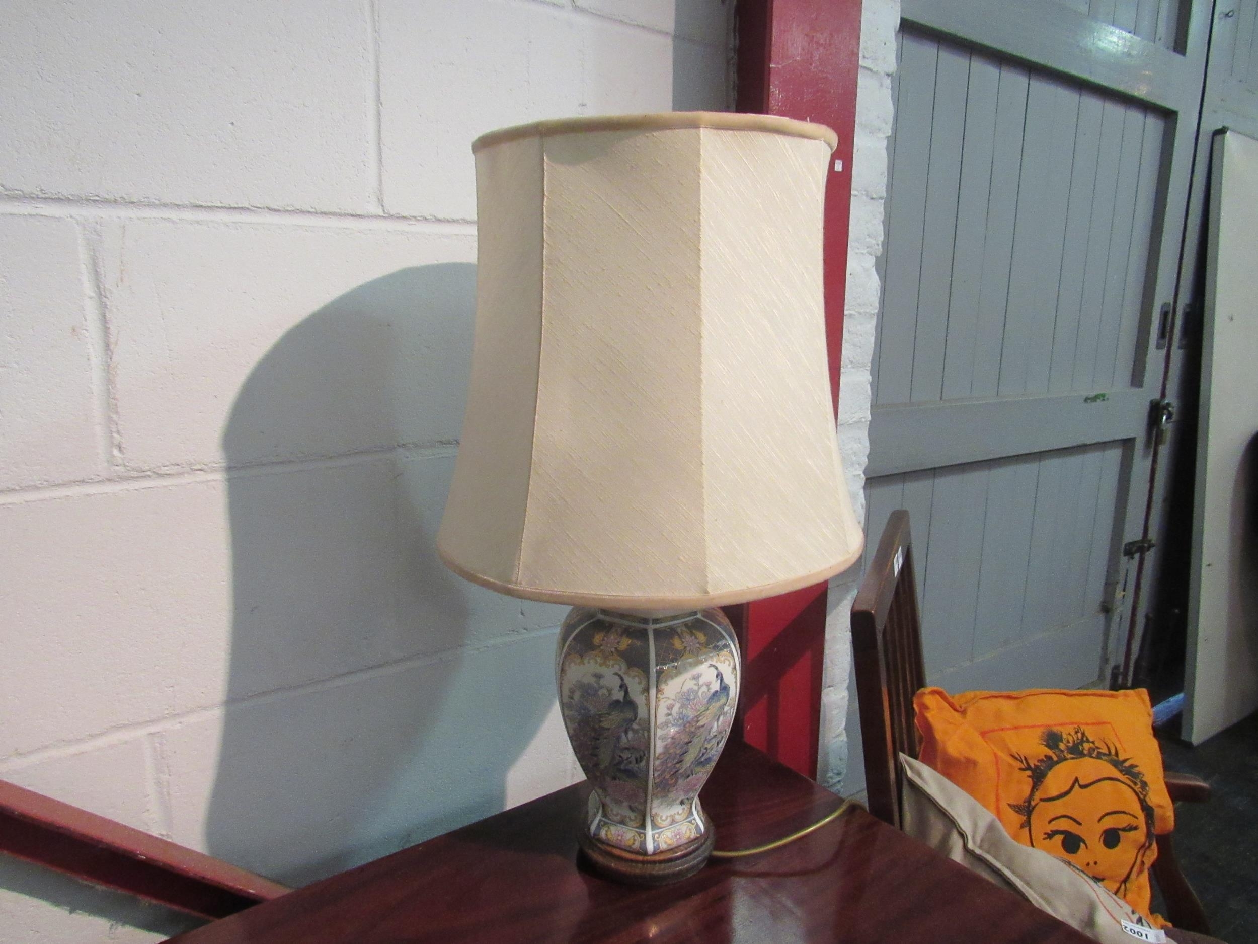 A modern ceramic table lamp with peacock decoration