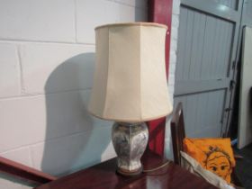 A modern ceramic table lamp with peacock decoration
