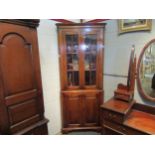 A modern oak glazed corner cabinet with bottom field panel doors. 199cm high x 84cm wide