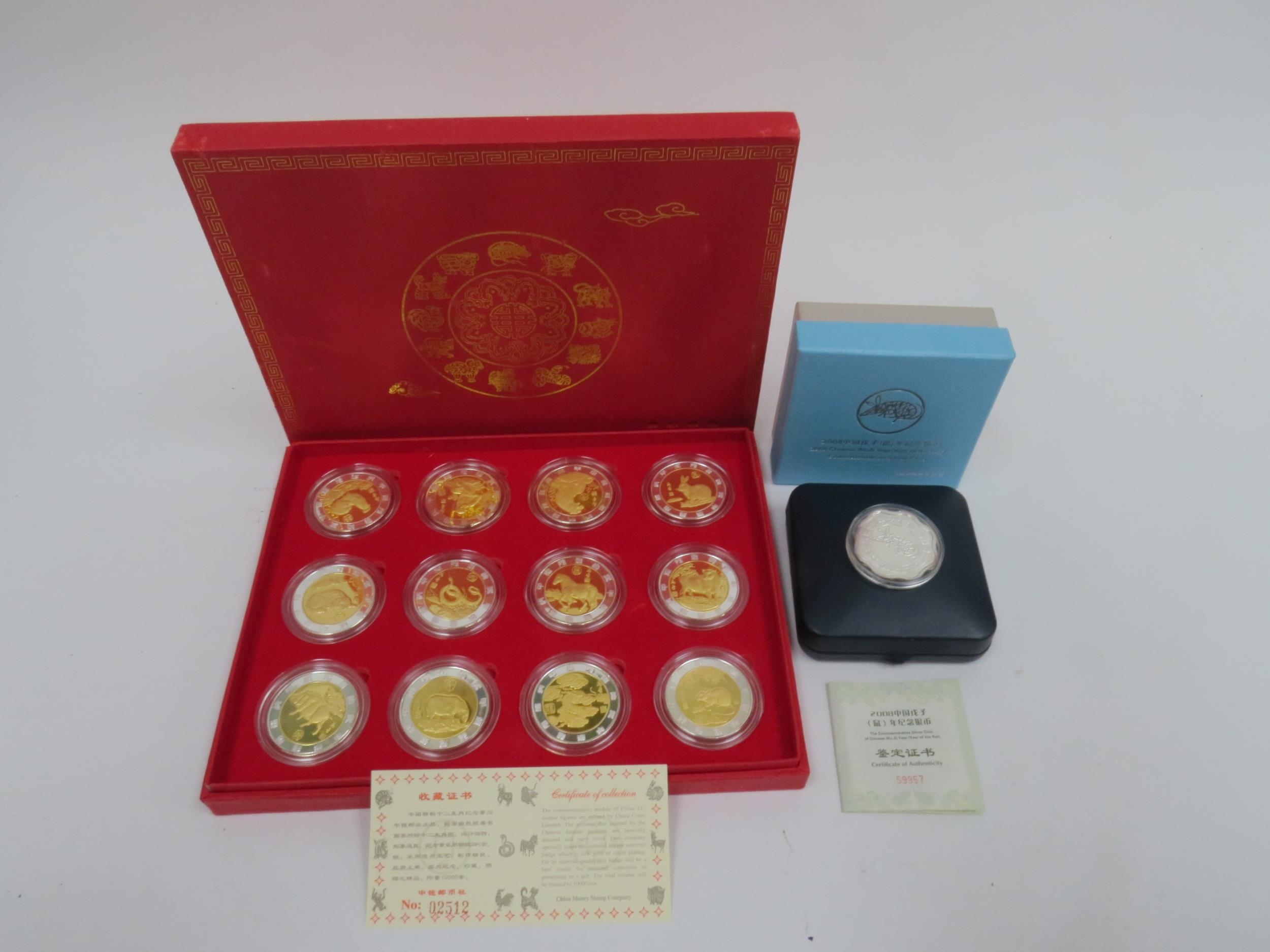 A China Money Stamp Company boxed set of 12 China Animal coins plated in silver and gold with - Image 2 of 4