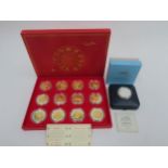 A China Money Stamp Company boxed set of 12 China Animal coins plated in silver and gold with