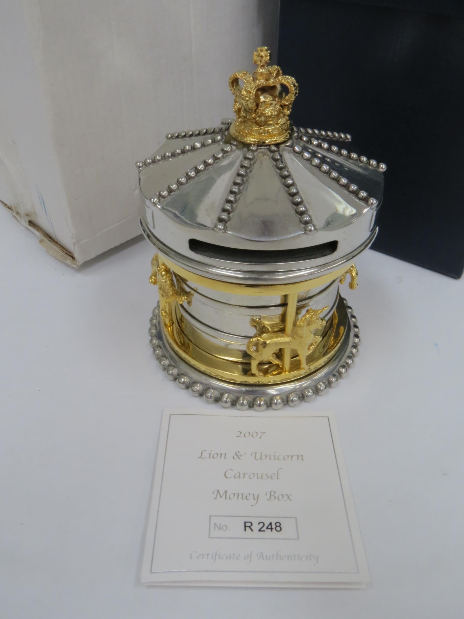 A Royal Mint "Lion & Unicon Carousel" money box in silver and pewter alloy with gold plating and set - Image 2 of 2