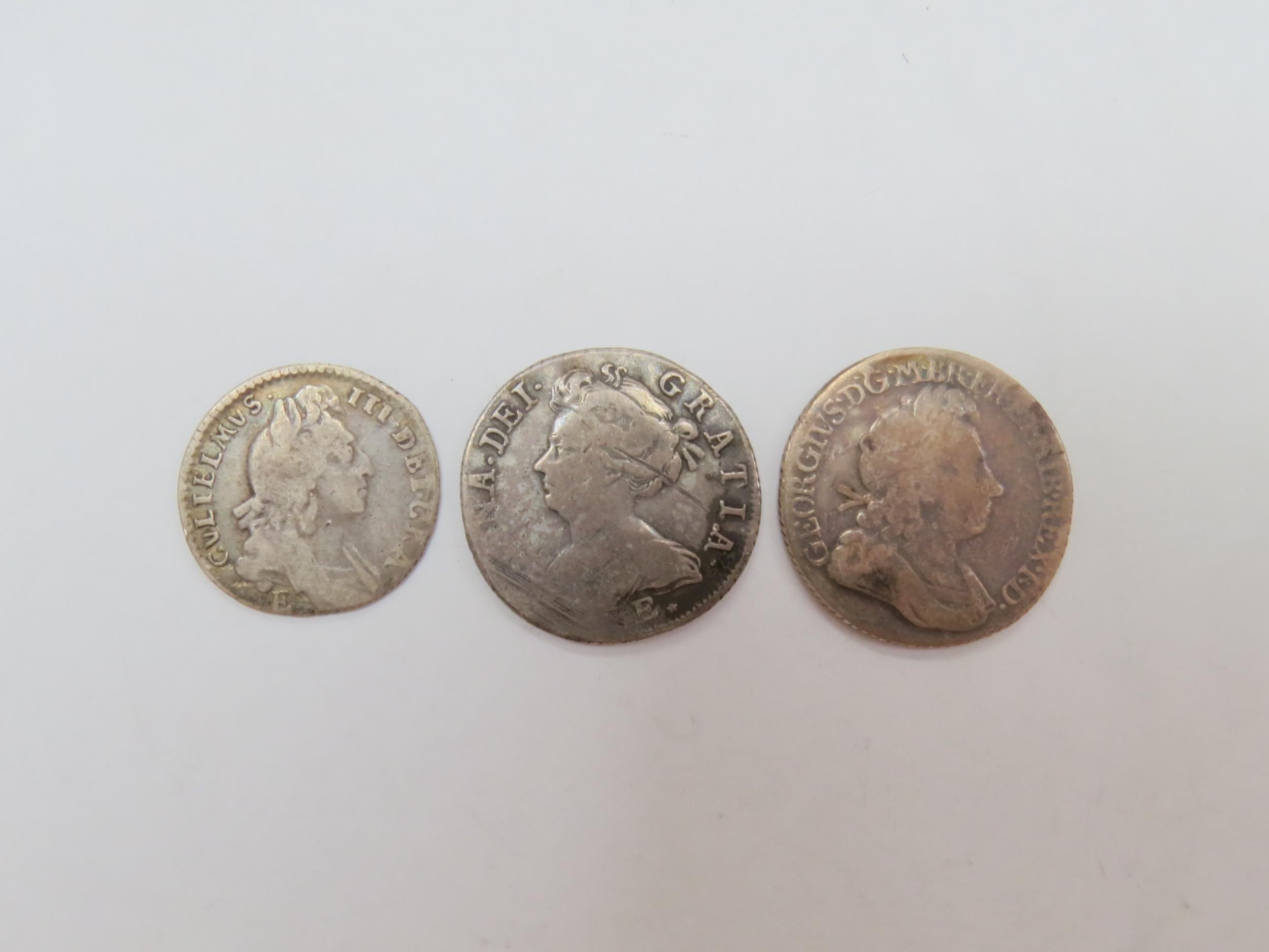 A 1696 William III sixpence, together with shillings of Queen Anne, 1708 & George I, 1720
