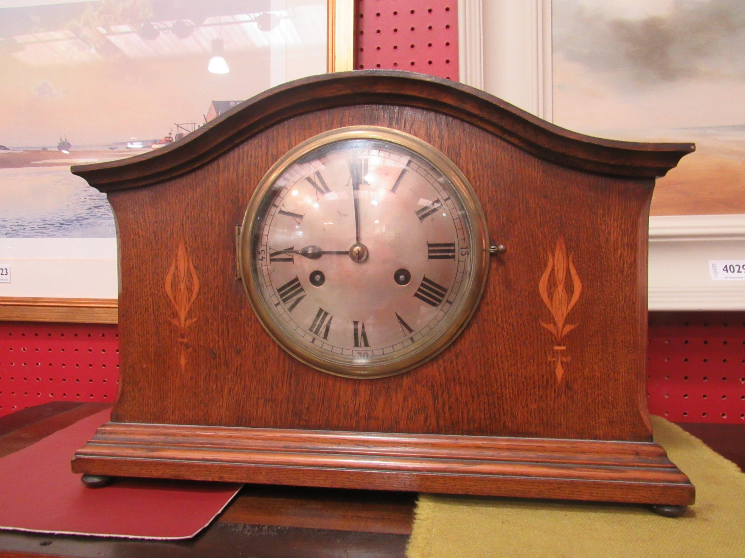 An early to mid 20th Century oak mantel clock, two train movement striking on a coiled gong, 28cm