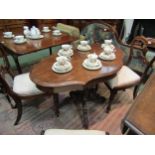 A Victorian walnut veneered side table with two drawers and central column on four carved legs on