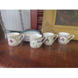 Four porcelain coffee cups and saucers