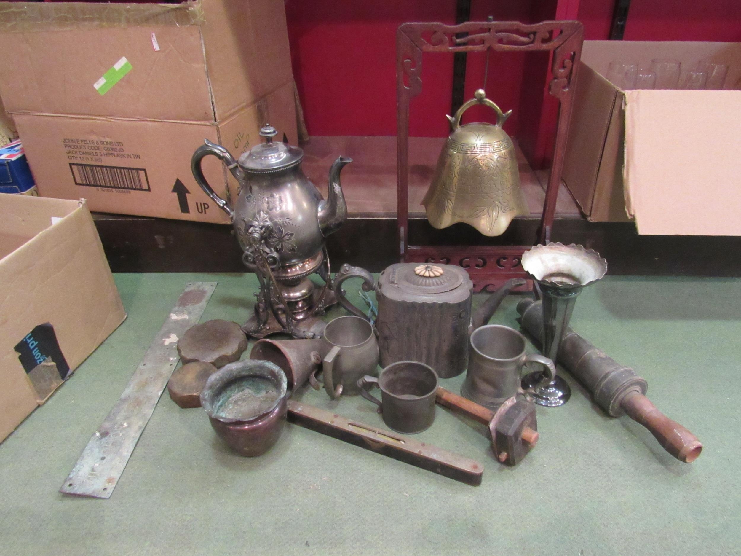 A box of mixed metalwares including spirit tea kettle, brass bell, etc. Also an ebony spirit level