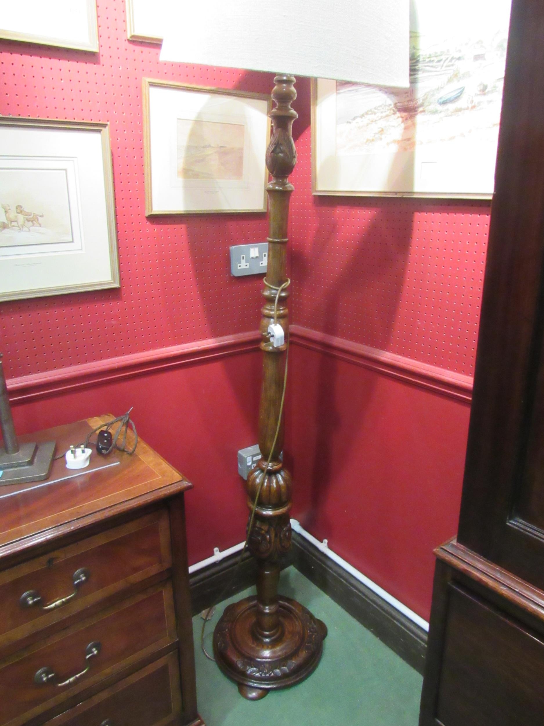 An oak standard lamp with shade the turned column with fluted and carved Tudor Rose decoration on