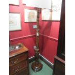 An oak standard lamp with shade the turned column with fluted and carved Tudor Rose decoration on