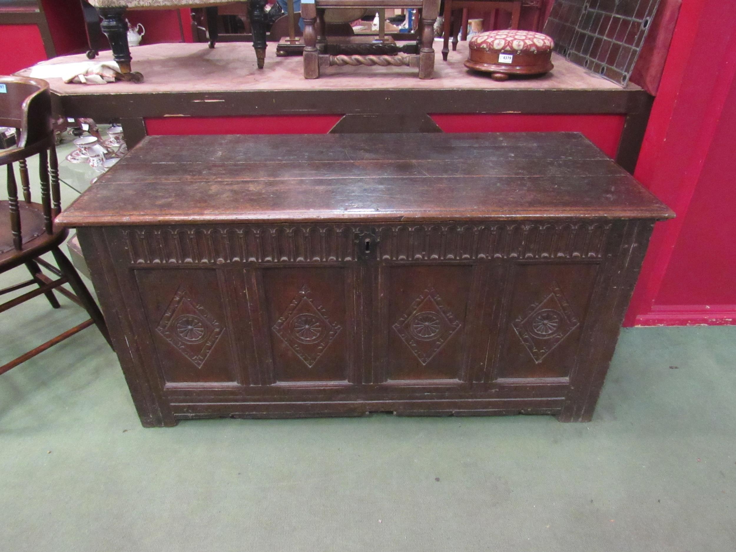 A four panel carved oak coffer, 63cm high x 130cm x 57cm