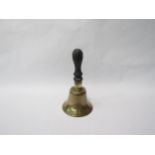 A brass hand bell with ebonised handle, 21.5cm high