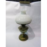 A British Made early to mid 20th Century brass oil lamp with white opaque shade