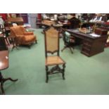 A walnut hall chair carved in Carolean style pierced with fretwork panel to front, cane work seat