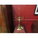 A large brass twin arm table lamp on reeded column to square base