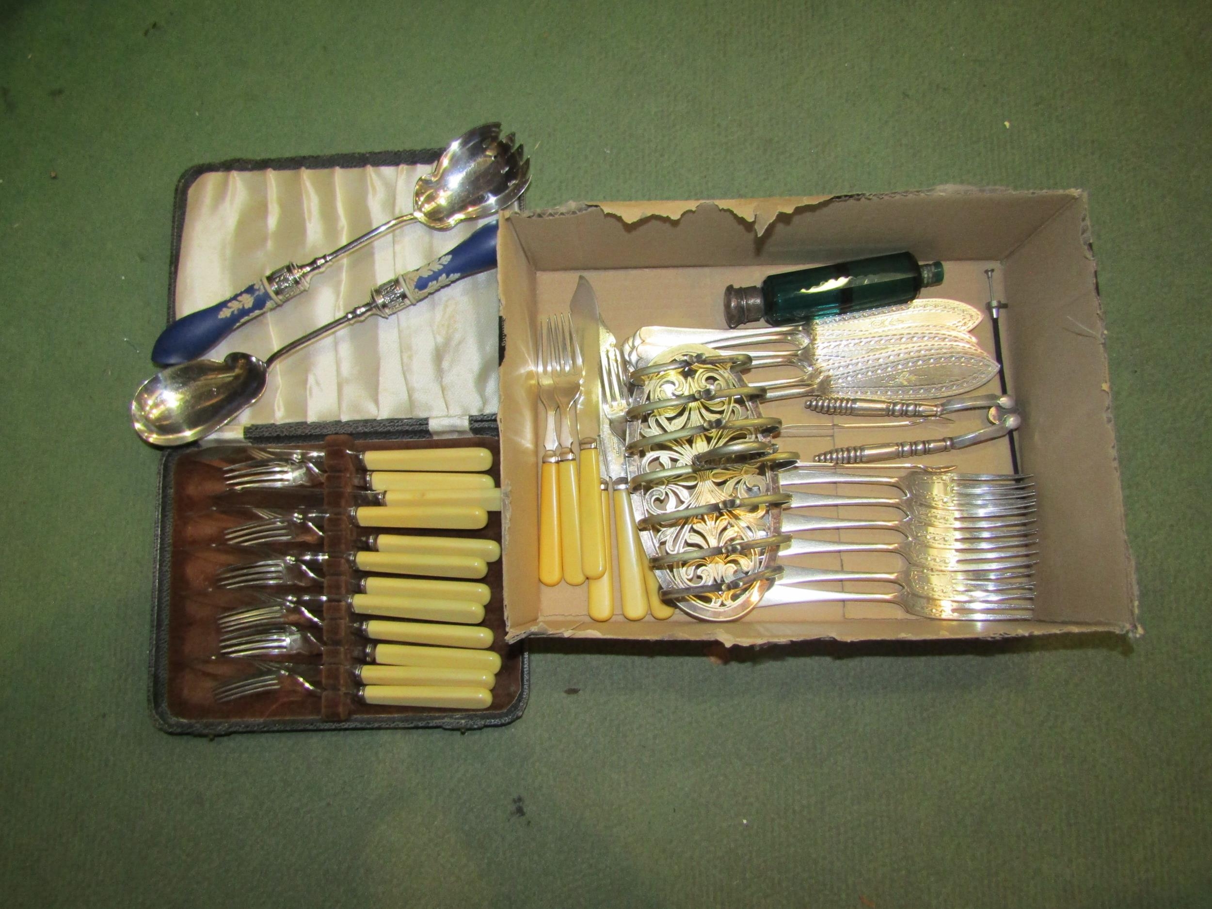 A box of plated wares including fish knives and forks, a pair of nutcrackers and tongs, jasperware