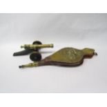 A pair of bellows with galleon design and a brass cannon figure on wooden stand