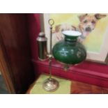 A vintage brass desk lamp with green glass shade