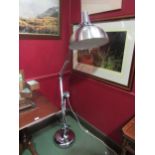 A chrome oversized angle-poise style standard lamp