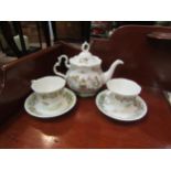 A Royal Doulton "Brambly Hedge" teapot, two cups and saucers, small chip to teapot lid