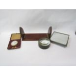 A dressing table mirror, table magnifier, leather travelling clock and a small book slide (4)