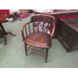 A circa 1900 oak desk chair on turned spindle supports and stretchers