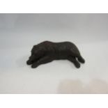 A recumbent carved wooden Black Forest bear, 21cm long