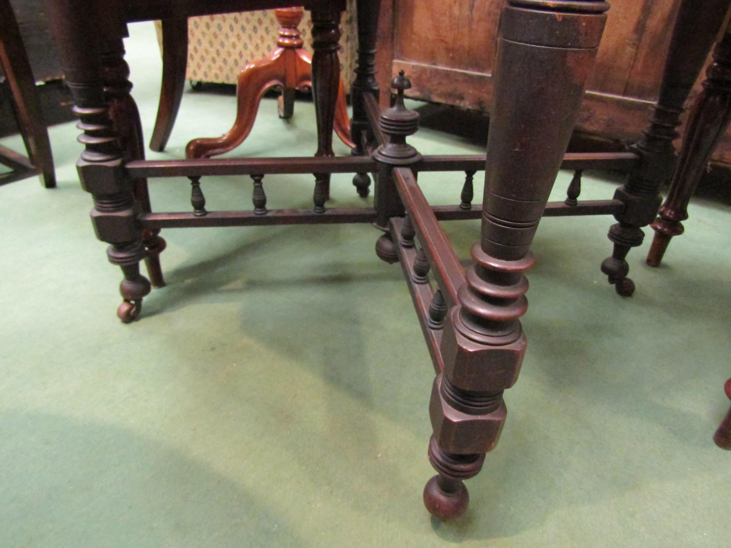 A walnut octagonal occasional table with turned cross supports and stretcher on ceramic castors, - Image 2 of 2