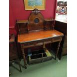 A Victorian walnut and ebonised relief lady's writing desk with angel and child circular plaque on a