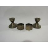 Two silver candlesticks (weighted base) and two silver napkin rings of hexagonal form