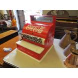 A cash register with Coca-Cola reproduction advertising