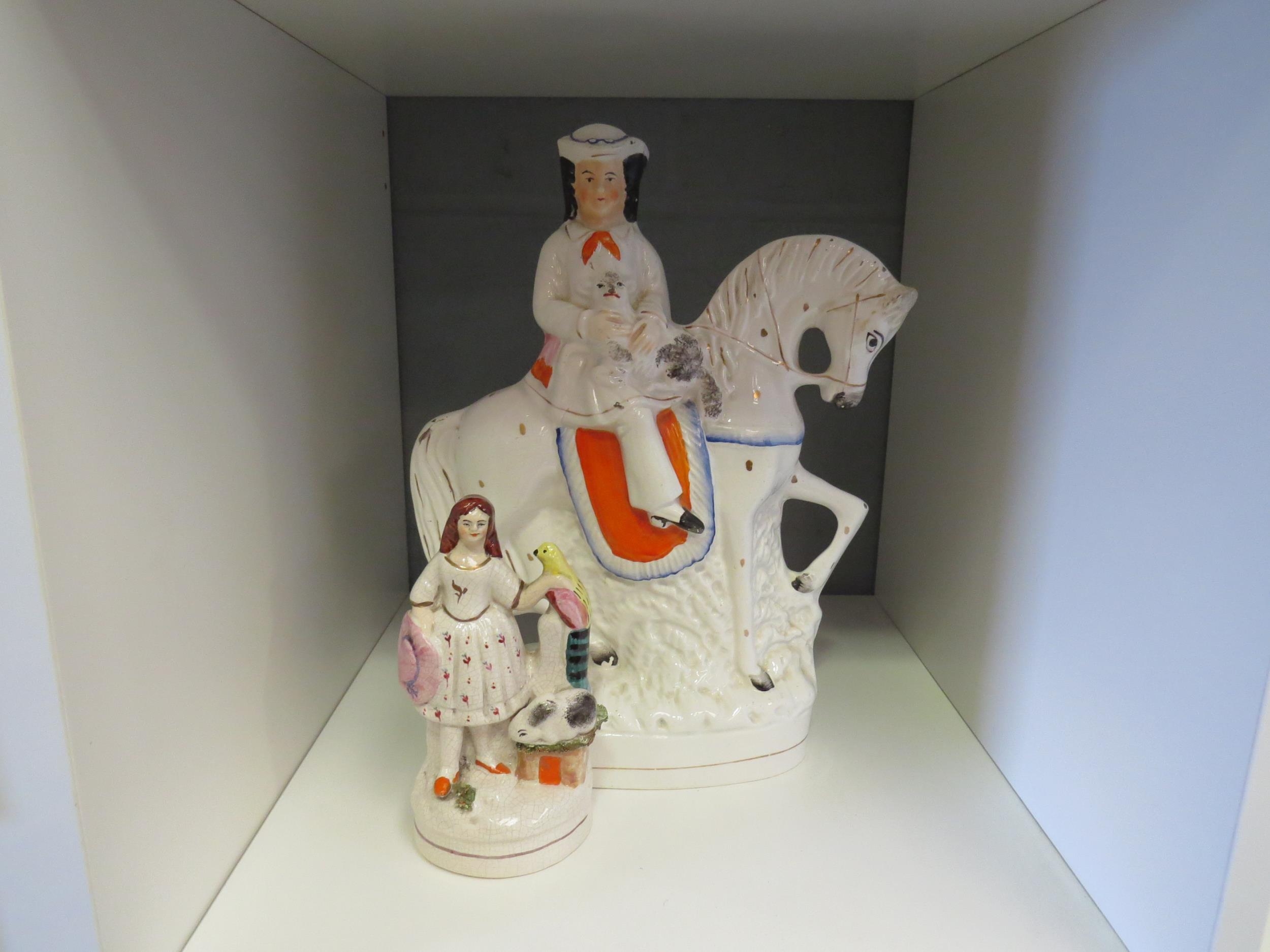 A Victorian Staffordshire flatback figure of gent on horseback holding an animal and another of lady