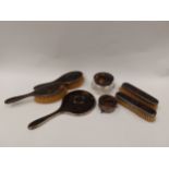 A tortoiseshell and silver dressing table set comprising of brushes, mirrors, boxes etc. (7)
