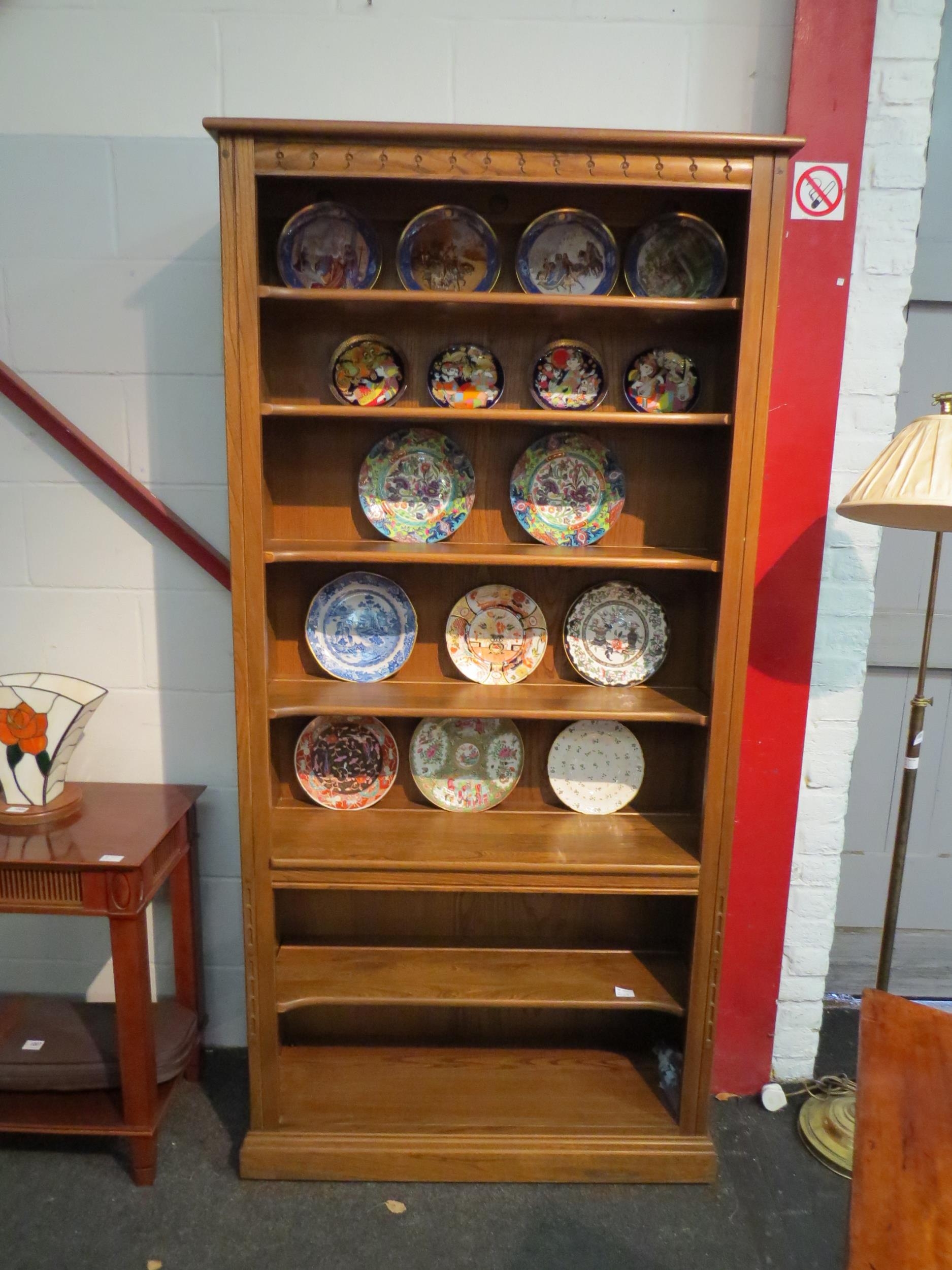 An Ercol elm full height bookcase, 197cm high x 97cm wide x 32cm deep