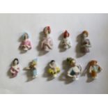 Nine glazed china half dolls and pin cushions including Pierrette, tallest 6.5cm