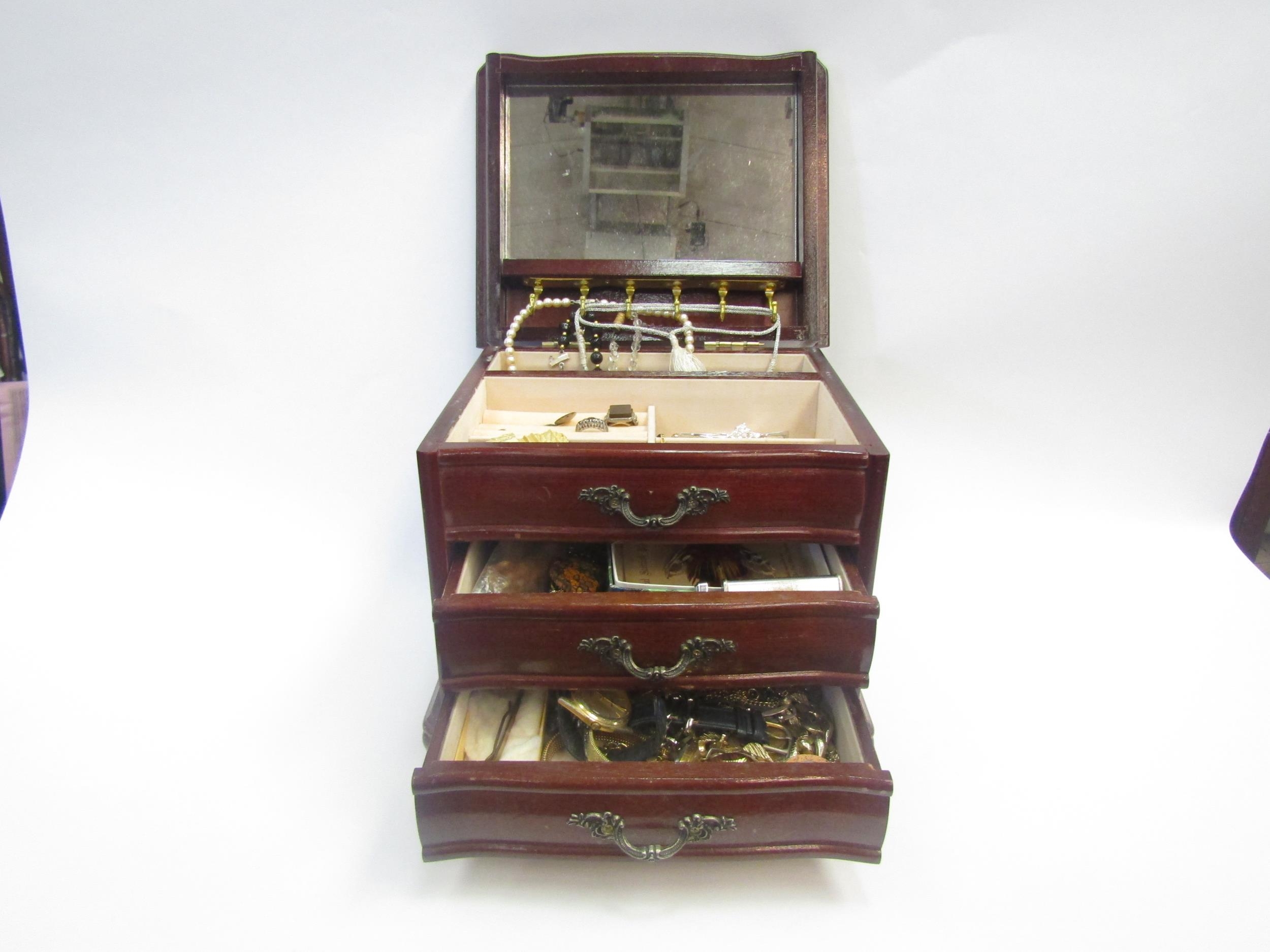 A jewellery chest with costume jewellery and other contents