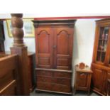 An early to mid 18th Century oak slim two door cupboard over two over two drawer base with swan neck