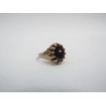 A 9ct gold mens ring with a claw set garnet