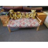 A beech two seater sofa with outswept arms